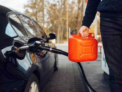 man-holding-canister-on-gas-station-fuel-filling.jpg