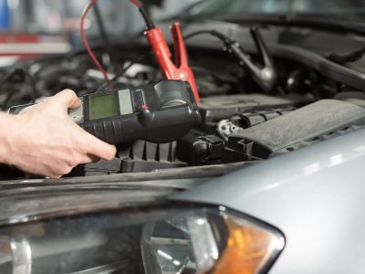 technician-hands-measure-the-voltage-of-the-battery-in-the-car-at-service-station.jpg